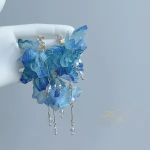 Elegant blue fabric flower tassel earrings with hanging crystals and faux pearl details