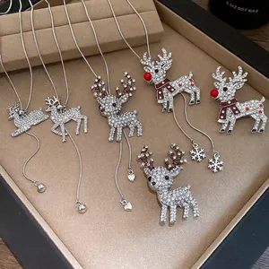Elegant rhinestone reindeer pendant necklaces and brooches displayed in a jewelry tray