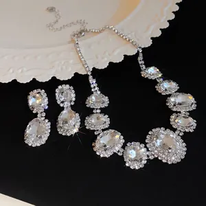 Detail view of French luxury jewelry set with oval rhinestones on black background
