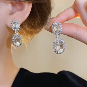 Elegant French style oval crystal earrings with pavé set rhinestones shown on model