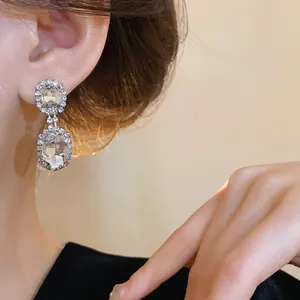 Elegant French style double elliptical pavé rhinestone drop earrings shown on an ear