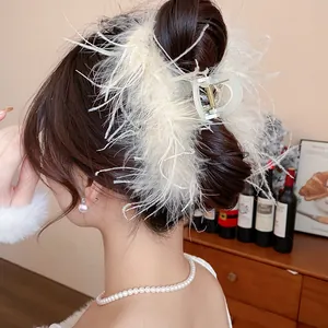 Detailed close-up of a French style white feather hair claw clip on an elegant bun