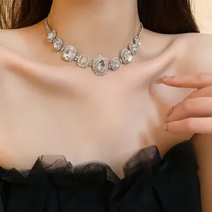 Elegant French luxury choker necklace with sparkling oval crystal clusters on a model
