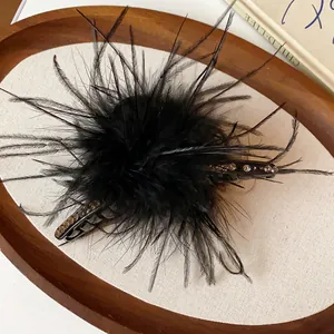 Detailed macro view of the fluffy black feather texture on the hair claw clip.