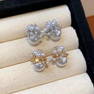 Elegant firework pearl stud earrings with sparkling cubic zirconia in a jewelry box