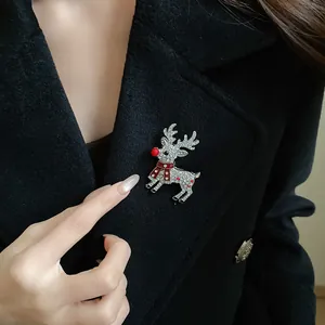 Close-up of a sparkling reindeer brooch with rhinestones on a black coat lapel