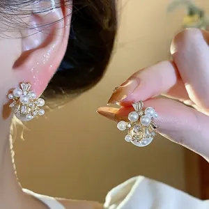 Elegant gold-plated firework pearl stud earrings with zircon inlay and French retro style