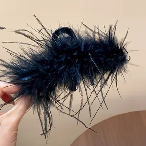 Close-up of black feather hair claw clip with elegant minimalist French design detail