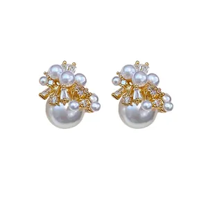 Elegant firework pearl stud earrings with sparkling cubic zirconia in gold plating