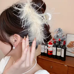 Detailed close-up view of an elegant cream feather hair claw clip styled on a classic updo