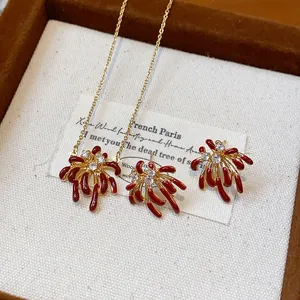 Detailed view of 18k gold plated firework jewelry set with red enamel and zircon