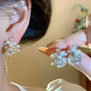 Detailed view of French vintage firework pearl earrings with zircon stones and gold plating