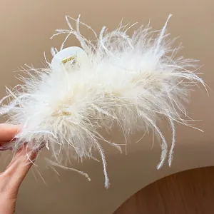 Close-up of elegant French style white feather hair claw clip for chic hairstyles