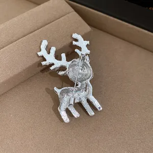 Detailed view of the back of a silver Christmas deer brooch showing the pin mechanism.