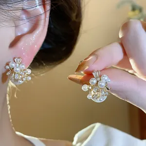 Detailed macro view of French retro fireworks pearl stud earrings with sparkling zirconia
