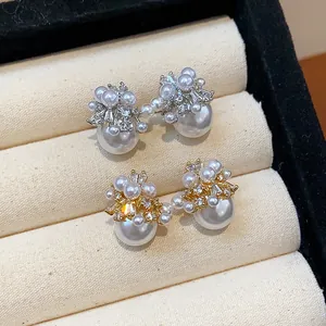 Macro detail of French retro pearl earrings with sparkling firework zircon and large pearls