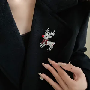 Sparkling rhinestone reindeer brooch pinned on a stylish black woolen winter coat.
