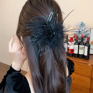 Elegant black feather hair claw clip detail view for stylish French hairstyles.