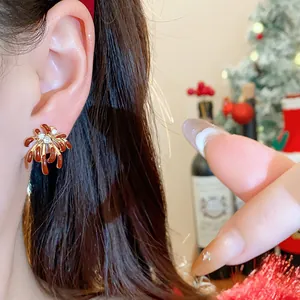 Close-up of elegant 18k gold plated firework stud earrings with sparkling zirconia