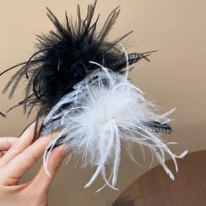 Close-up of elegant feather hair claw clips with rhinestone details in black and white