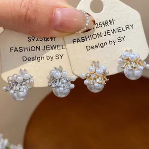 Macro view of exquisite firework pearl stud earrings with zircon inlay on display cards.