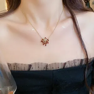 Close-up of elegant firework-shaped 18k gold plated necklace with sparkling zircon stones