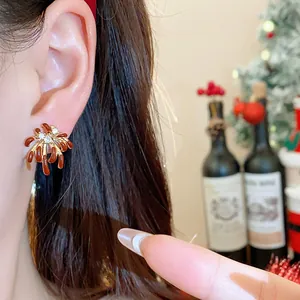 Close-up of elegant gold firework earrings with sparkling zircons worn by a model