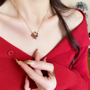 Close-up of elegant 18k gold plated zircon firework pendant necklace on model