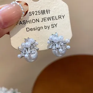 Macro detail of French vintage firework pearl stud earrings with S925 silver needle.