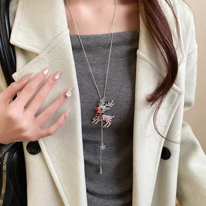 Detailed view of silver crystal reindeer necklace with red scarf and snowflake charm