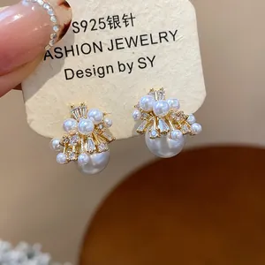 Detail view of S925 silver needle fireworks pearl earrings with sparkling zircon stones