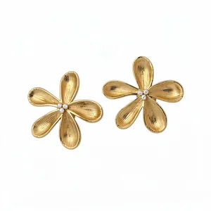 Elegant gold flower stud earrings with crystal centers in minimalist Korean style.