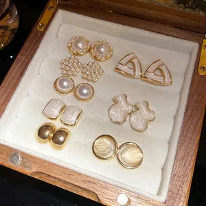 16pcs set of elegant pearl and cat-eye stone geometric stud earrings in a wooden box