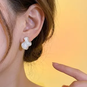 Elegant irregular geometric stud earring with textured cream finish for women