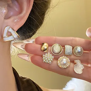 Vintage style gold-toned geometric stud earrings set with pearls and cat eye stones
