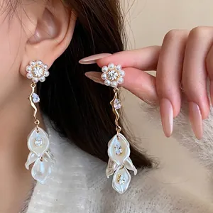 Elegant long zircon pearl flower tassel earrings with vintage design shown on a model