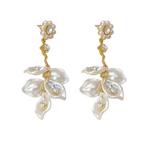 Elegant vintage long drop earrings featuring lustrous pearls, zircons, and white flower petals