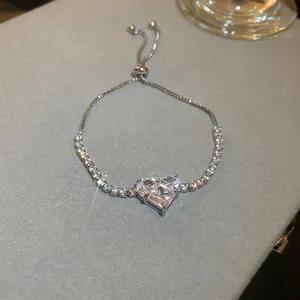 Close-up of sparkling heart-shaped zircon bracelet on grey velvet surface