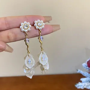 Detail view of elegant long tassel earrings featuring pearl flowers and zircon petals