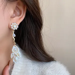 Elegant long tassel earrings with pearl flower and shimmering zircon stones detail