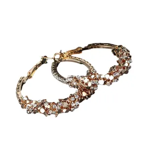 Elegant gold-toned hoop earrings with sparkling rhinestones and textured sequin accents