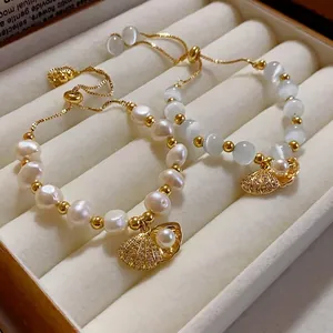 Elegant gold-plated bracelets featuring pearls, cat's eye stones, and detailed shell charms
