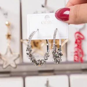 Close-up of sparkling rhinestone sequin hoop earrings with S925 silver needles on a card