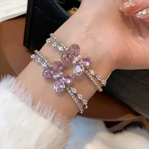 Elegant double-layer open bangle featuring a pink zircon butterfly and sparkling crystals