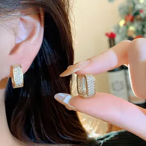 Close-up of 18k gold plated rectangular hoop earrings with sparkling zircon stones
