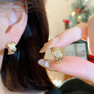 Macro view showing the fine details of 18k gold plated square earrings with cubic zirconia