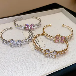 Detailed view of elegant zircon butterfly double-layer cuff bracelets in gold and silver