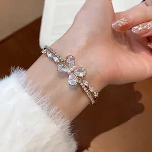 Exquisite detail of a double-layer zircon butterfly open bracelet worn on a woman's wrist