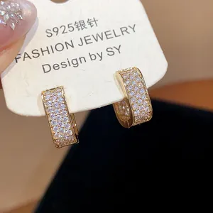 Detailed close-up of 18k gold plated square hoop earrings with micro-paved zircons
