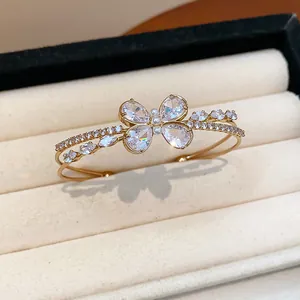 Exquisite close-up of a double-layer golden zircon butterfly bangle in a jewelry box